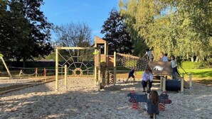 A playground with climbing structures and a slide.