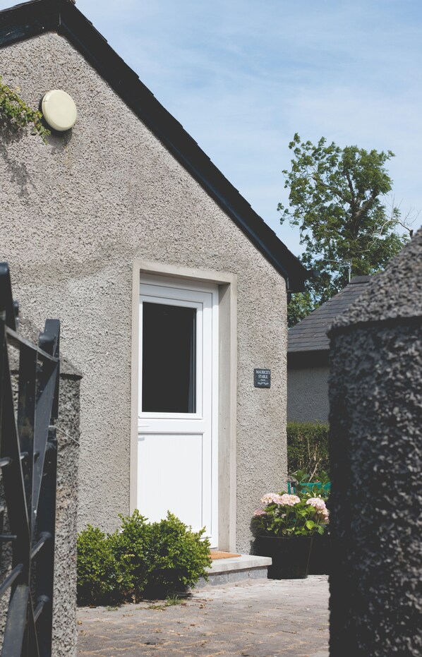 A building with a white door, a small window, and a sign that reads "MARKETPLACE." - The Stables at Ballygraffan, just outside Comber in the Strangford Lough area. (Comber)