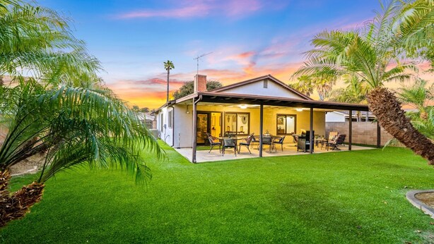 A house with a covered patio, a lawn, and palm trees. - 25% Off Sept & Oct, Full AC, Perfect For Families! (Ventura)