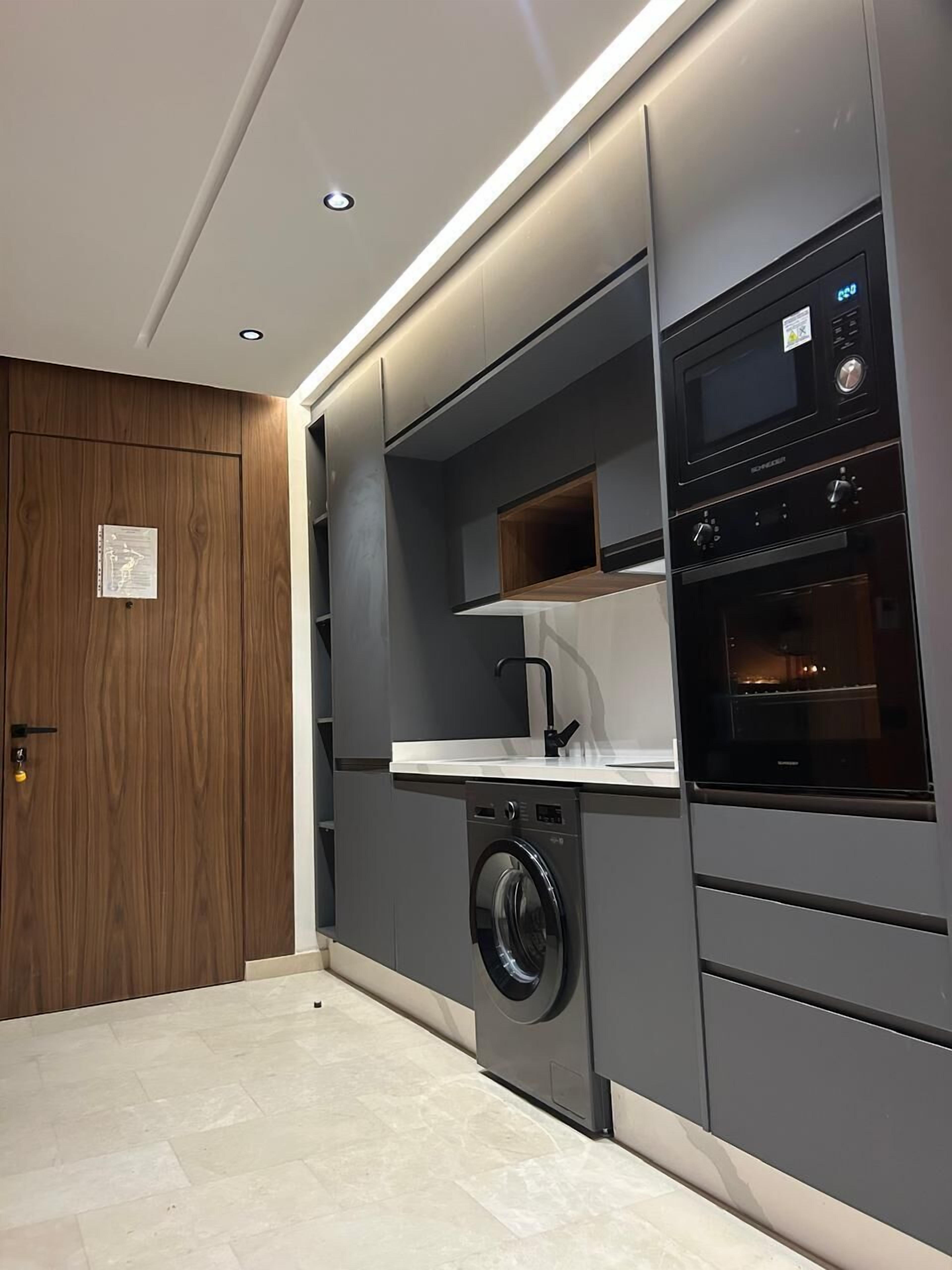 Deluxe Condo | Private kitchen | Full-size fridge, microwave, oven, stovetop
