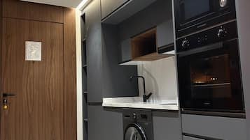 Deluxe Condo | Private kitchen | Full-size fridge, microwave, oven, stovetop