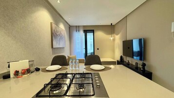 Deluxe Condo | Private kitchen | Full-size fridge, microwave, oven, stovetop