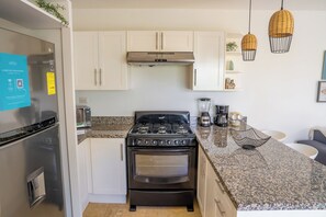 Fridge, microwave, stovetop, coffee/tea maker