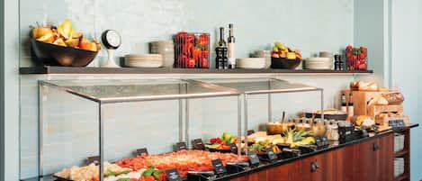 A buffet with various food items and a scale for weighing portions.