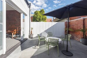 Step outside to your private courtyard with an umbrella for shade and ample space to dine alfresco.