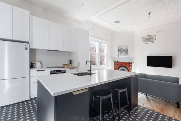 Additional seating is available at the breakfast bar for a quick bite or chats with the cook.