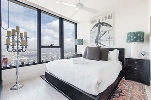 Retreat to bedroom two with a plush queen bed and soft natural light—a perfect mix of comfort and charm.