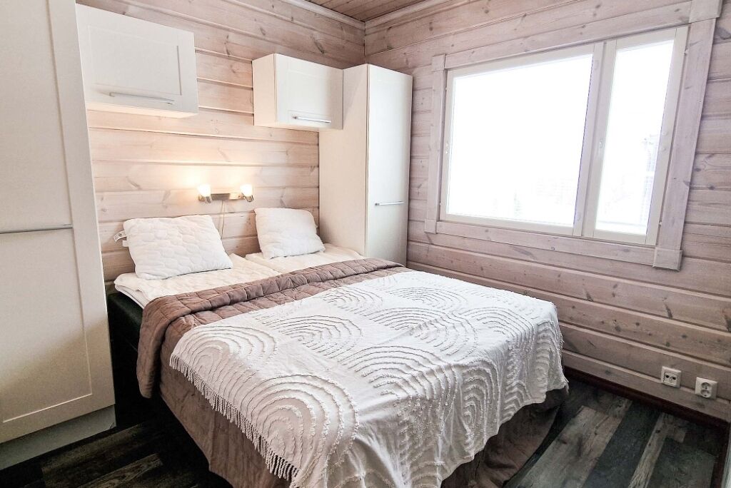 Une chambre à coucher avec un lit, une fenêtre et des placards intégrés.