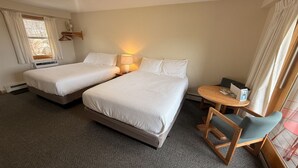 A hotel room with two beds, a small table with chairs, a lamp, and a window with curtains. - Juniper Motel*Double Queen*RM19*Dock*ATV Access*Waterfront*Pet Friendly*Boat Rentals (Greenville)