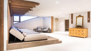 A modern room with a built-in massage bed, a wooden dresser, and a large mirror. - Wifi, 10m from ski slopes, swimming pool, sauna, hammam, terrace, parking, ski locker, 55-56m² (Aime)
