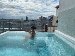 A rooftop swimming pool with a clear view of the cityscape in the background. - Puertovideo (Montevideo)
