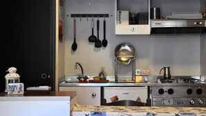 A compact kitchen with a sink, stove, and various utensils. - Relaxation a stone's throw from the sea. [Terrace] [Garage] (Zoagli)