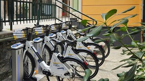 A row of electric bicycles parked at a charging station. - Relaxation a stone's throw from the sea. [Terrace] [Garage] (Zoagli)