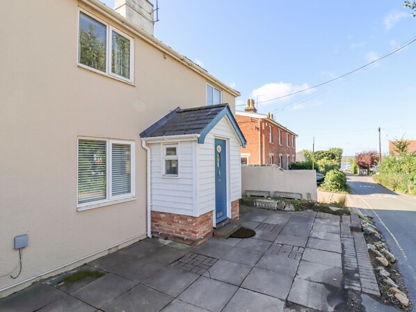 A residential property with a detached house and a small shed.