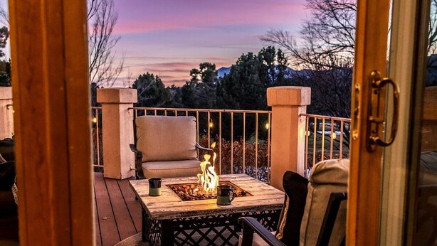 A deck with a fire pit, chairs, and a view of the landscape. - Pikes Peak Place: Relaxing Oasis w/Mtn Views (Colorado Springs)