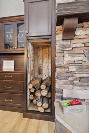 Cozy corner with a fireplace and storage cabinet.