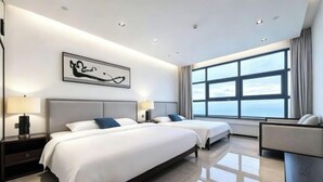 A modern hotel room with two beds, a large window, and a minimalist design. - Huidong Xunliao Bay New Coast Scenic Hotel (Haigongyuan Leisure Beach) (Huidong)