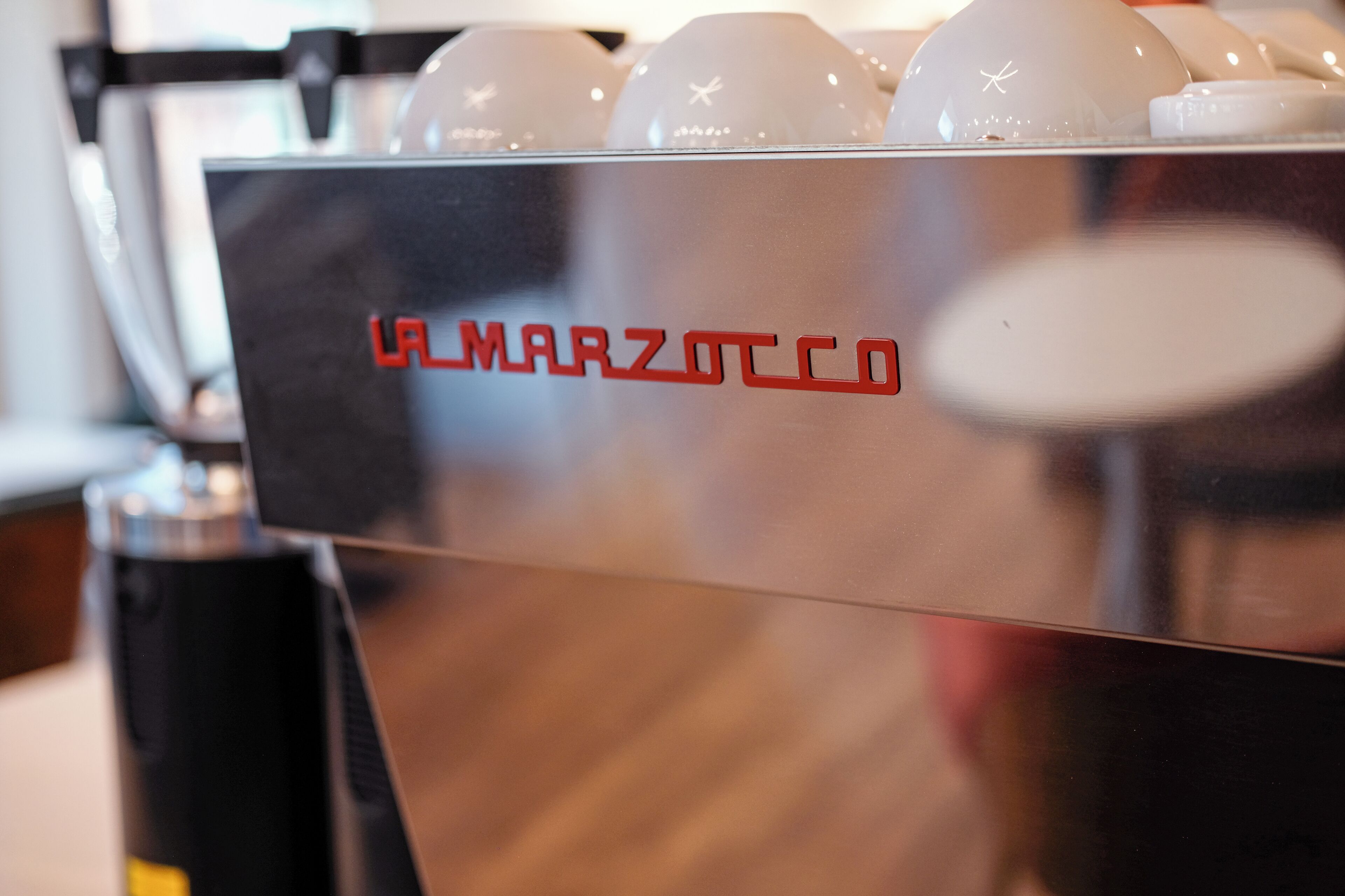 A coffee machine with the brand name "LA MARZOTTO CO" visible on its surface.