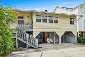 A two-story house with a front porch, a staircase, and a garage. - Oceanfront Beach House in Ocean Drive. LOTS of Charm and amazing views! (North Myrtle Beach)