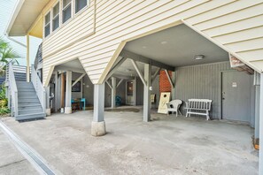 A building with a covered porch, a staircase, and a door marked 'PRIVATE.'