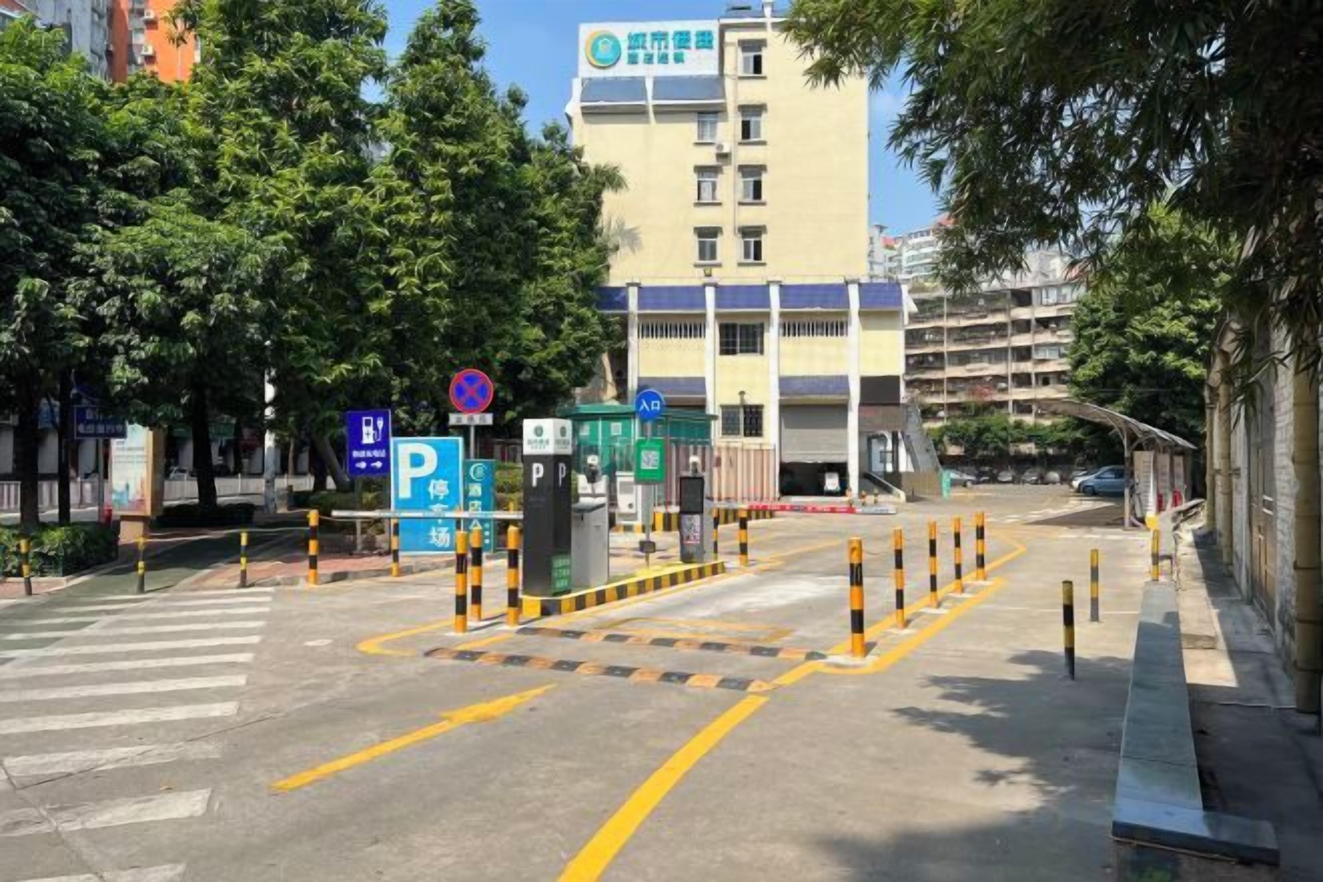 A parking area with marked spaces, a pedestrian crossing, and a building with multiple floors in the background.