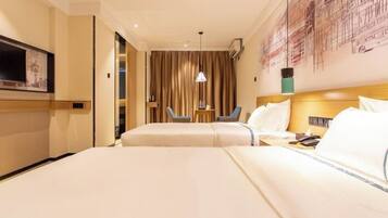 A hotel room with two beds, a TV, a desk, and a chair.