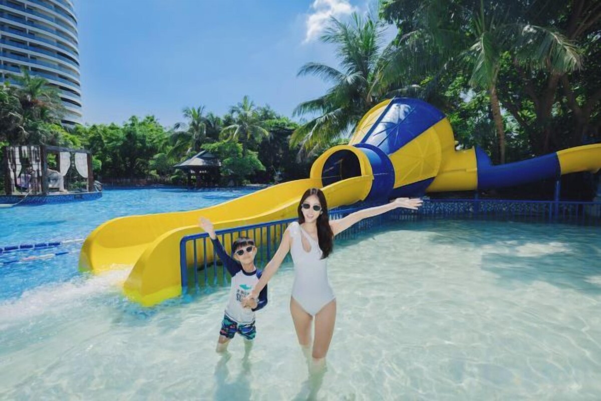 A water park with a large yellow and blue water slide.