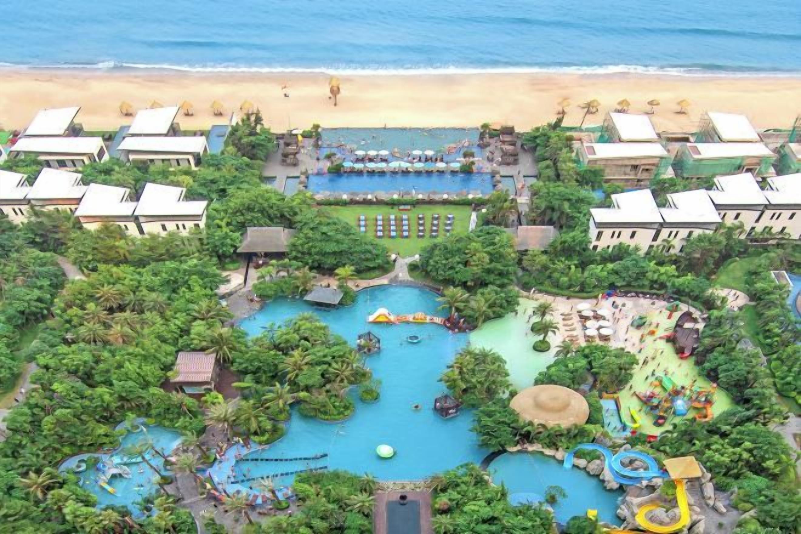 A resort with multiple swimming pools, a beach, and a variety of outdoor activities.