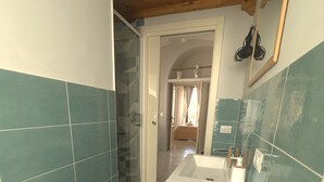 A bathroom with a wooden ceiling, a sink, and a shower area. - Rooms for Vacation and Relaxation. City Center SORRENTO Coast (Vico Equense)