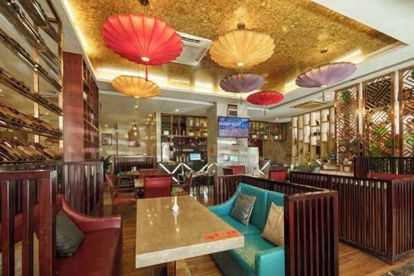 A restaurant interior with booths, a bar area, and a television screen. - Kaiwei Hotel (Wanning High-speed Railway Station Branch) (Wanning)
