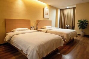 A hotel room with two beds, a bedside table, a potted plant, and a window with curtains. - Haojia Express Hotel (Zhuhai Gongbei Port Fuhuali Branch) (Zhuhai)