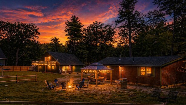 A backyard with a fire pit, outdoor seating, and a covered area.