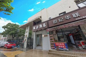 A storefront with a sign that reads 'Century Hotel' and another sign for 'Century Hotel'. - Miduo Hotel (Shanghai)