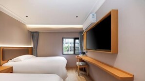 A hotel room with two beds, a desk, a TV, and a window. - Miduo Hotel (Shanghai)