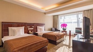 A hotel room with two beds, a desk, a television, and a window with curtains. - Beijing Shanxi International Hotel (Beijing South Railway Station) (Beijing)