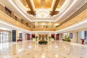 A spacious lobby with a polished floor, a grand chandelier, and a reception desk. - Beijing Shanxi International Hotel (Beijing South Railway Station) (Beijing)