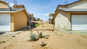 A residential street with houses featuring attached garages and satellite dishes.