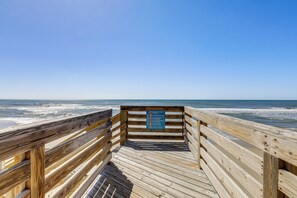 A wooden boardwalk leading to the beach with a sign listing beach rules. - Oceanfront Gem w/ Views in North Topsail Beach (North Topsail Beach)