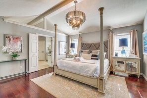 A four-poster bed with a large mirror, a chandelier, and a console table with lamps. - Relax By Pool, Soak in Hot Tub: Plano Home (Plano)