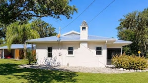 A single-story house with a gabled roof, a chimney, and a small front porch.