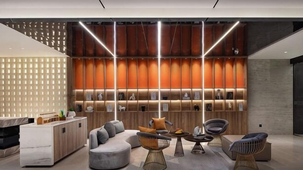 A modern lobby with a reception desk, seating area, and a wall with illuminated panels. - Skyscraper Hotel (Wenling Jingyuan Branch) (Wenling)