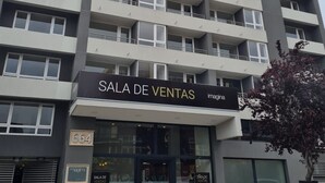 Ein mehrstöckiges Gebäude mit einem Schild, auf dem „SALA DE VENTAS“ steht, das auf einen Verkaufsbereich hinweist.