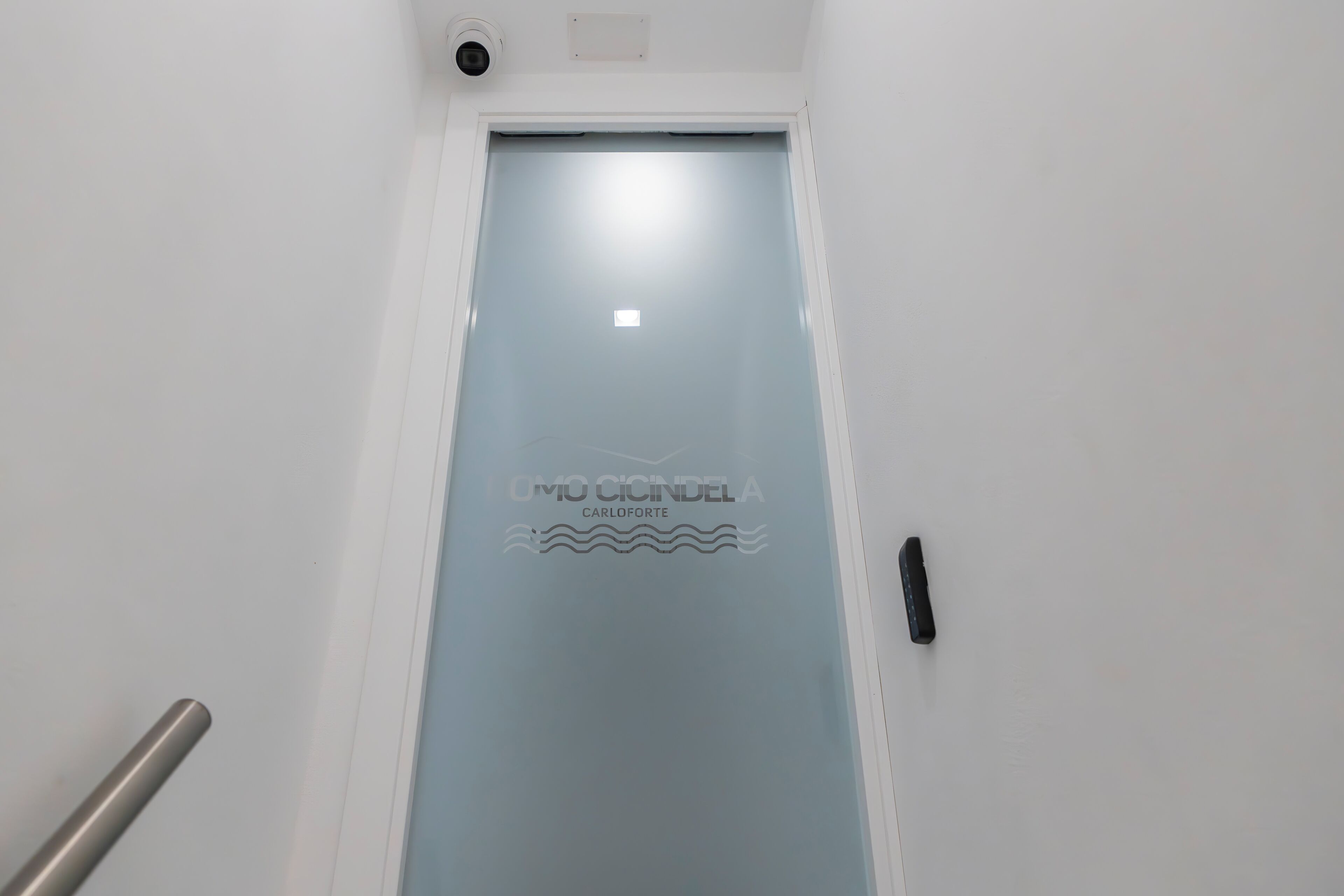 A door with a frosted glass panel and a logo.