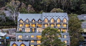 A multi-story hotel with a modern architectural design, featuring balconies and large windows. - Lantern 28 - 1 bedroom and Loft with 1 carpark (Thredbo)