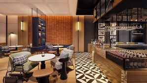 A modern lounge area with seating, a bar, and a patterned floor. - Four Points By Sheraton Kunming Dongfeng Square (Kunming)