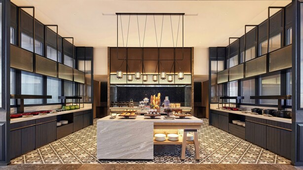 A modern kitchen with a central island, dark cabinetry, and a patterned floor. - Four Points By Sheraton Kunming Dongfeng Square (Kunming)
