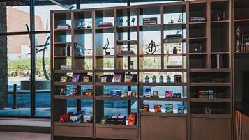 A bookshelf with books, CDs, and snacks.