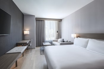 In-room safe, desk, laptop workspace, blackout drapes at AC Hotel Las Vegas Symphony Park