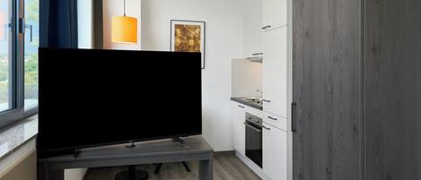 A modern kitchen with a built-in oven, a microwave, and a sink.