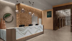 A reception area with a marble counter, wooden wall panels, and hanging pendant lights.